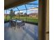 Screened-in lanai with outdoor seating overlooking the backyard and lush landscaping at 5721 Sunset Falls Dr, Apollo Beach, FL 33572