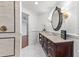 Bathroom with dark wood vanity, large mirror, and patterned floor at 6515 Stonington S Dr, Tampa, FL 33647