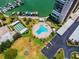 Aerial view of community pool, marina, shuffleboard, and parking at 7625 Sun Island S Dr # 305, South Pasadena, FL 33707