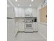 White kitchen with updated appliances and white shaker cabinets at 7625 Sun Island S Dr # 305, South Pasadena, FL 33707