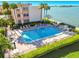 Relaxing waterfront pool area with lounge chairs and BBQ at 7625 Sun Island S Dr # 305, South Pasadena, FL 33707