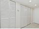 Bright hallway with multiple white louvered doors and light flooring at 7625 Sun Island S Dr # 305, South Pasadena, FL 33707