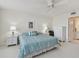 Main bedroom with king-size bed, ceiling fan and updated furnishings at 7625 Sun Island S Dr # 305, South Pasadena, FL 33707