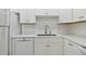 Clean white kitchen features updated appliances and cabinetry at 7625 Sun Island S Dr # 305, South Pasadena, FL 33707