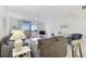 Living room features water views and gray sofas at 7625 Sun Island S Dr # 305, South Pasadena, FL 33707