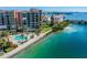 Waterfront condo building with pool and parking; aerial view at 7625 Sun Island S Dr # 305, South Pasadena, FL 33707