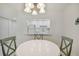Bright dining area with a round table and chairs, offering a view into the updated kitchen at 7625 Sun Island S Dr # 305, South Pasadena, FL 33707