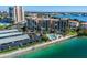 Aerial view of condo building with pool and parking near waterfront at 7625 Sun Island S Dr # 305, South Pasadena, FL 33707