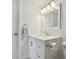 Clean bathroom with white vanity and mirror at 7625 Sun Island S Dr # 305, South Pasadena, FL 33707