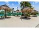 Relaxing picnic area with thatched umbrellas at 7625 Sun Island S Dr # 305, South Pasadena, FL 33707