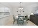 Dining area with white table and teal chairs near kitchen at 7625 Sun Island S Dr # 305, South Pasadena, FL 33707