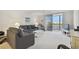 Living room with water view and comfortable gray sofa at 7625 Sun Island S Dr # 305, South Pasadena, FL 33707