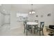 Bright dining area with white table and teal chairs at 7625 Sun Island S Dr # 305, South Pasadena, FL 33707
