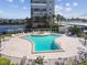 Community pool with plenty of lounge chairs at 7625 Sun Island S Dr # 305, South Pasadena, FL 33707