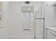 White kitchen with updated appliances and cabinetry, and view to laundry closet at 7625 Sun Island S Dr # 305, South Pasadena, FL 33707