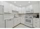 Modern white kitchen with updated appliances and white subway tile backsplash at 7625 Sun Island S Dr # 305, South Pasadena, FL 33707