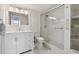 Bright bathroom with white vanity, shower, and linen closet at 7625 Sun Island S Dr # 305, South Pasadena, FL 33707
