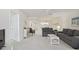 Open concept living room with gray sofas and water views at 7625 Sun Island S Dr # 305, South Pasadena, FL 33707