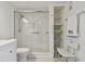 Bathroom featuring a walk-in shower, toilet and shelving at 7625 Sun Island S Dr # 305, South Pasadena, FL 33707