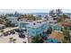 An elevated view showcases a teal building in a coastal neighborhood at 8200 Bayshore Dr # 12, Treasure Island, FL 33706