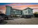 Two-story light teal building with parking and ocean views at 8200 Bayshore Dr # 12, Treasure Island, FL 33706