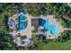 Community pool with lounge chairs and shaded areas at 8604 Egret Point Ct, Tampa, FL 33647