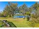 Serene backyard view of a pond and trees at 8604 Egret Point Ct, Tampa, FL 33647