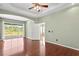 Well-lit bedroom with wood floors and access to another bedroom at 8604 Egret Point Ct, Tampa, FL 33647