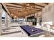 Outdoor bar area with pool table and wicker lighting at 9458 Shorebird Ct, Parrish, FL 34219