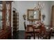 Formal dining room with chandelier, large mirror and hutch at 19109 Cherry Rose Cir, Lutz, FL 33558