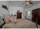 Main bedroom with wooden furniture and a ceiling fan at 19109 Cherry Rose Cir, Lutz, FL 33558