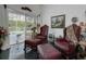 Cozy sitting area with leather chairs and ottoman near pool access at 19109 Cherry Rose Cir, Lutz, FL 33558