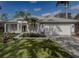 Single story home with a two-car garage and manicured lawn at 19109 Cherry Rose Cir, Lutz, FL 33558