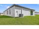Rear view of a single-Gathering home with grassy backyard at 29502 Fedora Cir, Brooksville, FL 34602