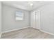 Well-lit bedroom with wood-look floors and double closet at 4190 67Th N Ave, Pinellas Park, FL 33781