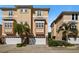 Three story townhome with two car garages, palm trees, and landscaping at 562 Rivercrest Ln, Tarpon Springs, FL 34689