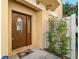 Inviting front door entry with decorative glass and landscaping at 562 Rivercrest Ln, Tarpon Springs, FL 34689