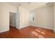 Bedroom with wood flooring and access to hallway at 562 Rivercrest Ln, Tarpon Springs, FL 34689
