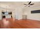 Open concept living room and kitchen with hardwood floors and a fireplace at 562 Rivercrest Ln, Tarpon Springs, FL 34689