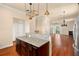 Kitchen island with granite countertop, dark wood cabinets, and stainless steel appliances at 562 Rivercrest Ln, Tarpon Springs, FL 34689