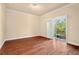 Spacious bedroom with hardwood floors and access to a private balcony at 562 Rivercrest Ln, Tarpon Springs, FL 34689