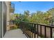 Private balcony overlooking lush trees and a residential area at 562 Rivercrest Ln, Tarpon Springs, FL 34689