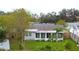 Back of house, showcasing the screened porch and yard at 6431 Butte Ave, New Port Richey, FL 34653