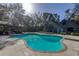 Inviting freeform pool with spa, spacious patio, and covered lanai at 6828 Old Pasco Rd, Wesley Chapel, FL 33544