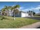 Gray house with palm trees and a white fence at 8651 Gulf Blvd, St Pete Beach, FL 33706