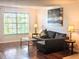 Living room with hardwood floors, large windows, and comfortable seating at 10200 Gandy N Blvd # 921, St Petersburg, FL 33702