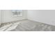 Bright bedroom features neutral carpet, white walls, and a large window that provides natural light at 11207 Shoreline Trl, Parrish, FL 34219