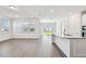 Open-concept living space featuring plank flooring, recessed lighting, and access to the kitchen at 11207 Shoreline Trl, Parrish, FL 34219