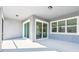 Covered patio with grey walls and white flooring; sliding glass doors for easy outdoor living at 11207 Shoreline Trl, Parrish, FL 34219