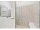 Walk-in shower featuring large tiles, glass door, shower head, and a bench at 11505 Waterway Dr, Parrish, FL 34219